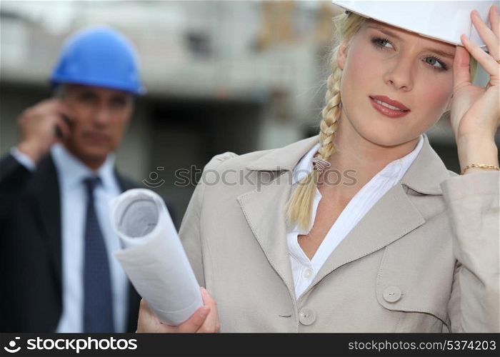 Female architect with plans on site