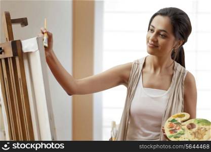 Female artist painting on canvas
