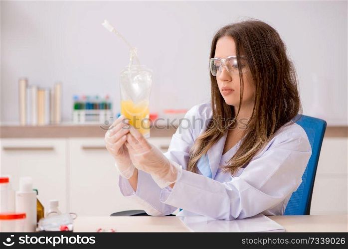 Female assistant with bag of plasma in the lab  