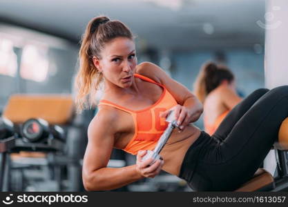 Female Athlete Doing Highly Effective Sit-Ups with Dumbbell in Modern Gym. Female Athlete Doing Highly Effective Sit-Ups with Dumbbell 