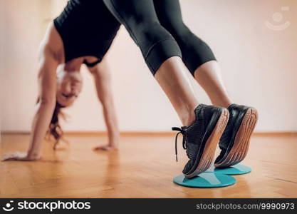 Female Athlete Exercising with Sliding Discs.