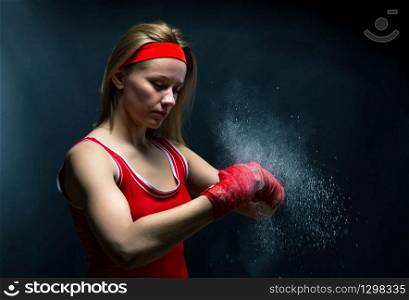Female athlete in red boxing bandages and sportswear. Fighting sport. Female athlete in boxing bandages and sportswear