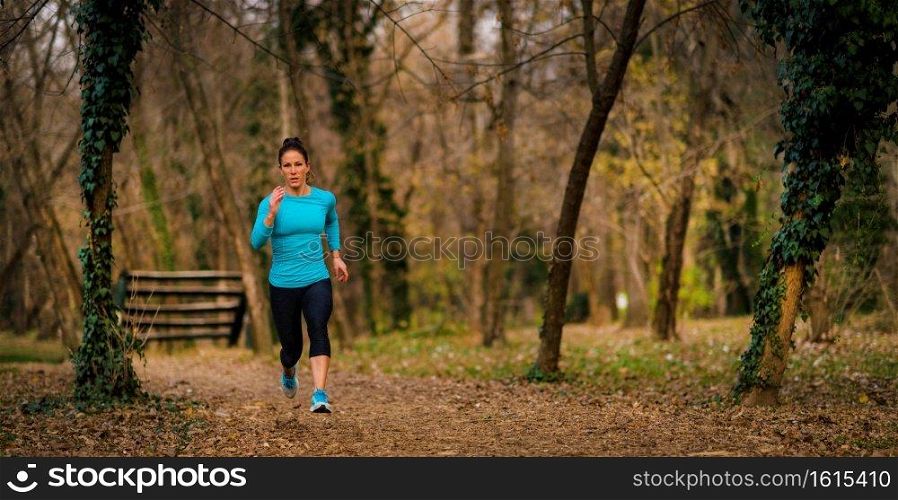 Female Athlete Jogging in Park. Autumn, Nature. Woman Jogging. Park, Nature 