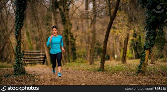 Female Athlete Jogging in Park. Autumn, Nature. Woman Jogging. Park, Nature