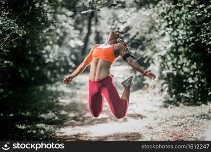 Female athlete jumping in the park