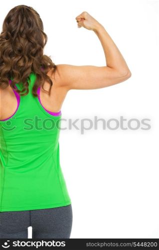 Female athlete showing biceps. rear view