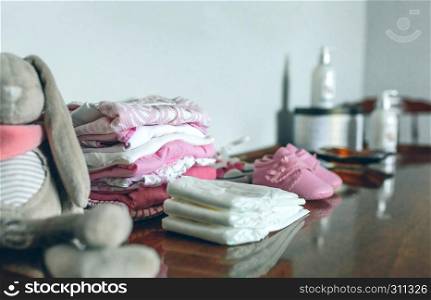Female baby clothes ready for her arrival. Baby clothes ready for her arrival