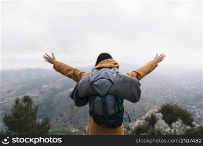 female backpacker standing top mountain loving nature