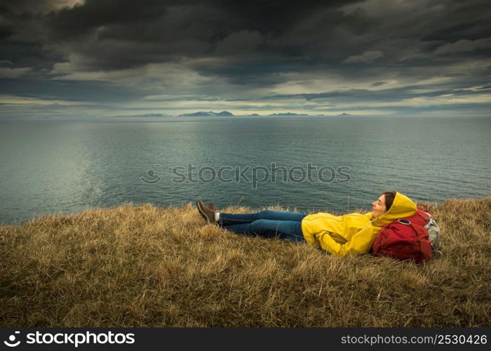 Female backpacker tourist in Icleand resting after a long day of adventures