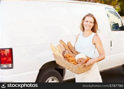 Female Baker Delivering Bread Standing In Front Of Van