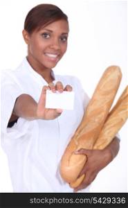 Female baker holding baguettes and a blank business card