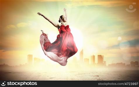 Female ballet dancer. Image of female ballet dancing outdoor against city background