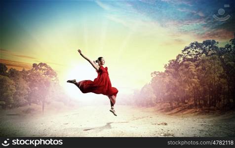 Female ballet dancer. Image of female ballet dancing outdoor against sunset background