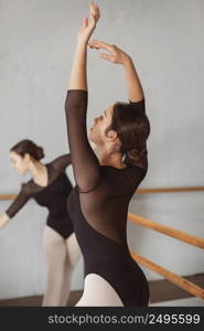 female ballet dancers training together leotards pointe shoes