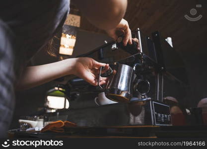 female barista prepares espresso from coffee machine caf. High resolution photo. female barista prepares espresso from coffee machine caf. High quality photo