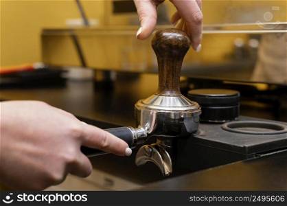 female barista using professional coffee cup