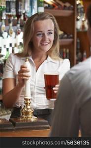 Female Bartender Serving Drink To Male Customer
