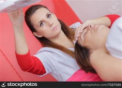 female beautician doctor with woman patient in spa wellness center