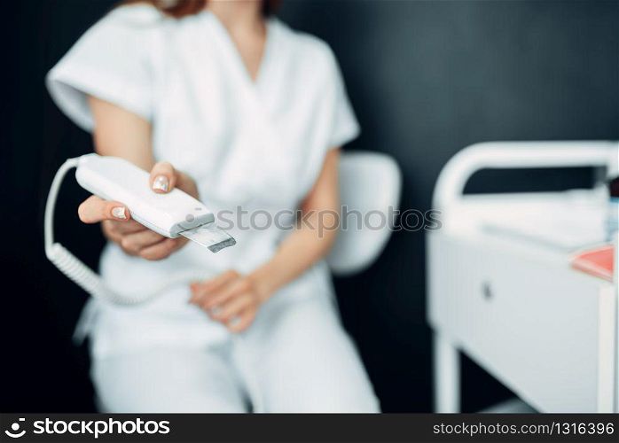 Female beautician hands prepares equipment to procedure, cosmetology cabinet. Doctor in white uniform in spa salon, beauty medicine. Female beautician hands prepares equipment