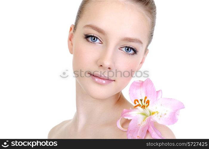 female beautiful clean young face with lily on the shoulder