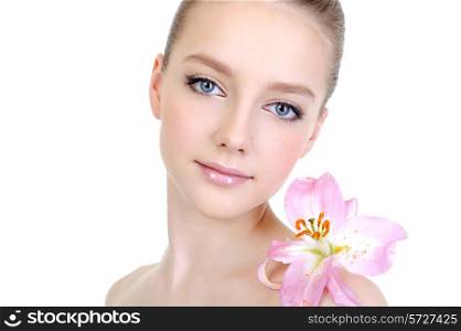 female beautiful clean young face with lily on the shoulder