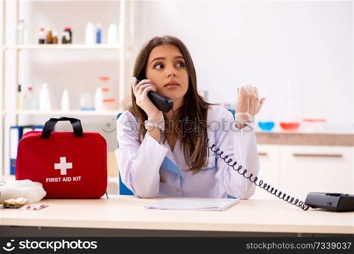 Female beautiful doctor with first aid bag 