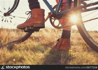 Female boots and vintage bike