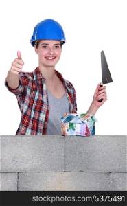 Female bricklayer thumbs up