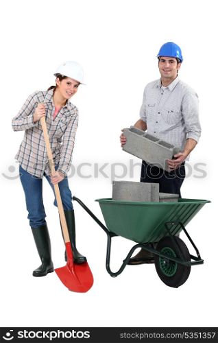 female bricklayer with shovel and male counterpart