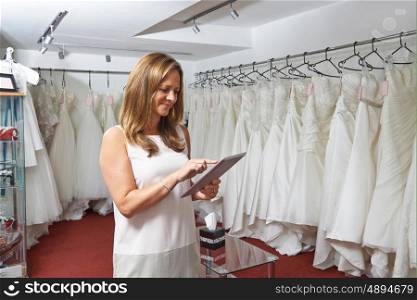 Female Bridal Store Owner Using Digital Tablet