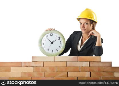 Female builder and clock on white