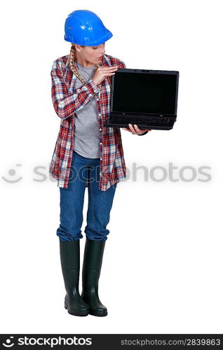 Female builder holding laptop