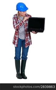 Female builder holding laptop