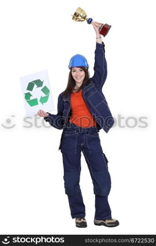 Female builder holding trophy and recycling logo