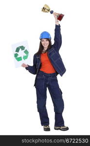 Female builder holding trophy and recycling logo