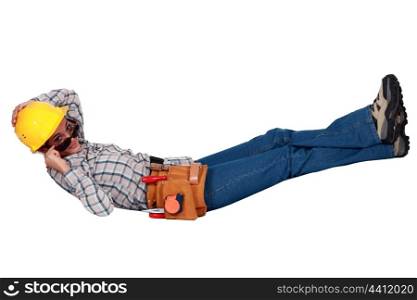 Female builder in sunglasses laying down
