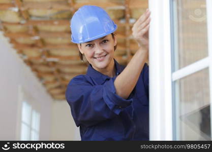 female builder looking at a window