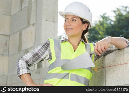 female builder plastering the walls