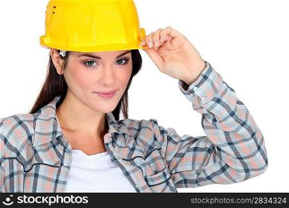 Female builder touching hat