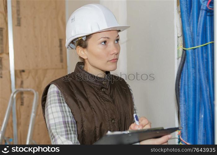 female builder with a clipboard