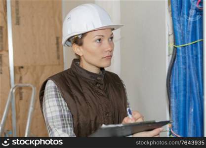 female builder with a clipboard