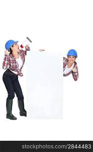 Female builder with poster and megaphone