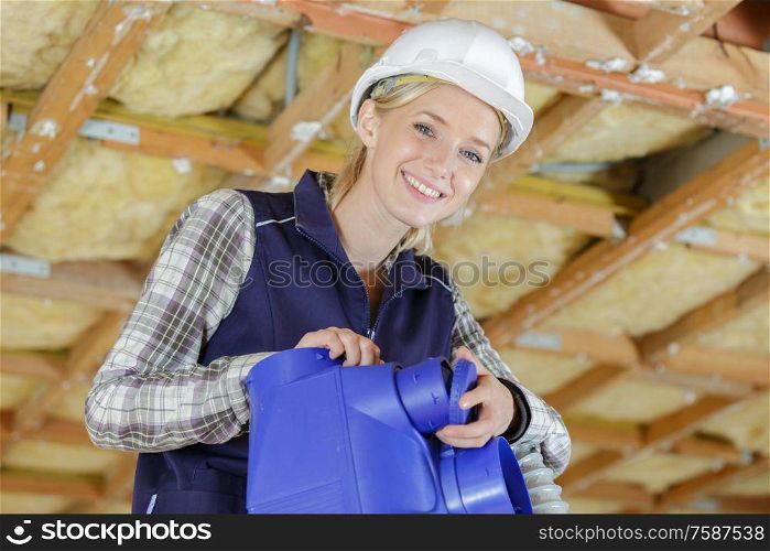 female builder working with ceiling