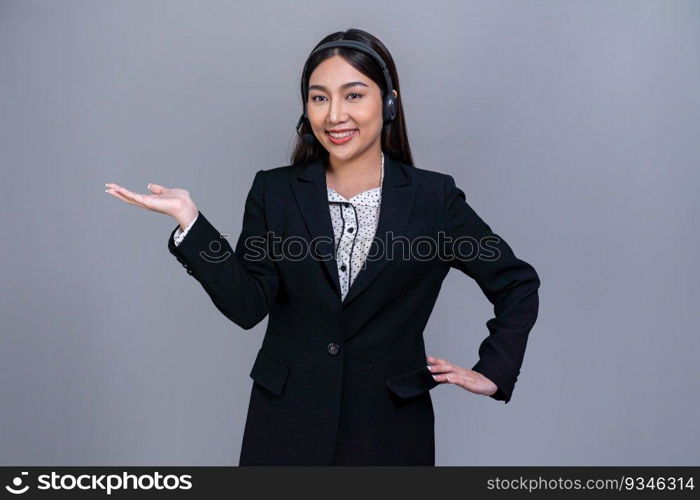 Female call center operator wearing headset and formal suit standing confidently with holding hand gesture for product advertisement or HR recruitment on isolated background. Jubilant. Female call center operator wearing headset making hand gesture. Jubilant