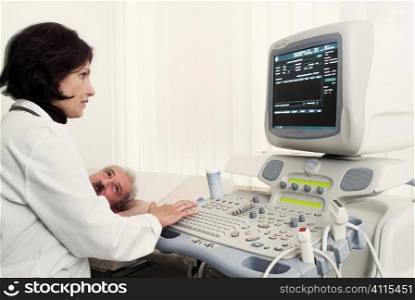 Female cardiologist operates machine