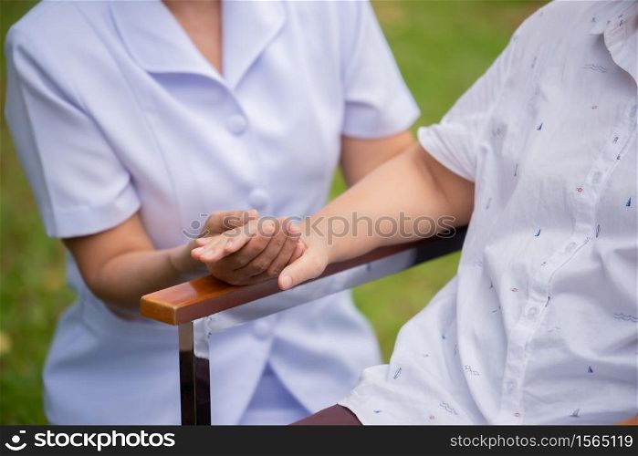Female Caretaker With Senior Woman In Yard