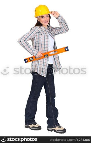 female carpenter holding ruler with hand to hard hat