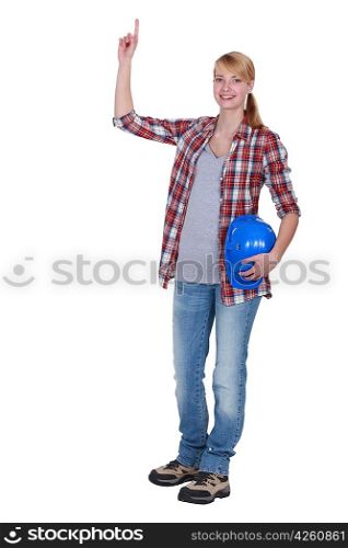 female carpenter pointing upwards