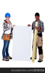 female carpenter posing with senior instructor holding copyspace