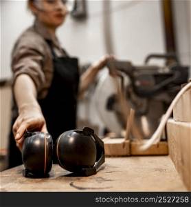 female carpenter studio with headphones